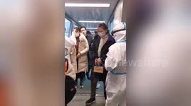 Hangzhou International Airport staff check tourists' temperatures amid coronavirus scare
