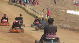 Mountain tribes race against each other in handmade wooden go-karts in Thailand