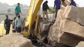 People rescue excavator driver after loose rock crush vehicle in eastern India