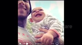 Baby laughing hysterical after uncles failed golf attempt.