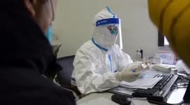 Doctors in protective clothing treat patients in Wuhan hospital during the coronavirus outbreak