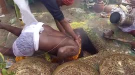 Hindu priest sticks head into firepit for religious festival in northern India