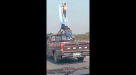 Reckless passenger does press-ups in the back of moving pickup truck in Thailand
