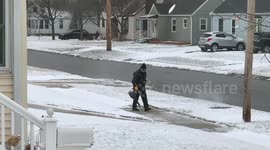 No shovel? No problem! Man uses a leaf blower to clear the snow