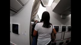 Flights attendants on a Cathay Pacific flight to Hong Kong wear face masks