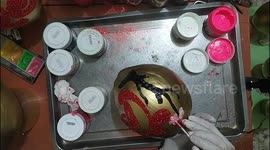 Vietnamese people paint coconuts with gold and traditional symbols for lunar new year