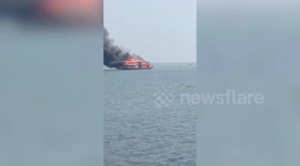 Double-decker houseboat spotted sailing while engulfed in flames off India's south coast