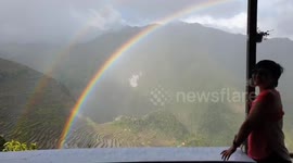 Beautiful double rainbow stretches over valley in the Philippines