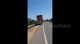 Erratic drunk driver swerves container truck around highway in India