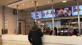 KFC staff in a notorious Birmingham branch plagued by spate of violent attacks now serve customers through protective CHICKEN wire