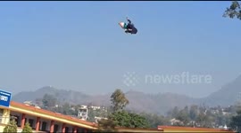 Paraglider has lucky escape after crash-landing while showering flowers at Indian event