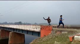 Indian villagers sprint across active railway bridge ahead of trains