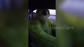 Beijing taxi driver wears protective clothing to prevent any potential coronavirus infection