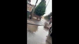 Pipe bursts in West Midlands, flooding the street and affecting houses.