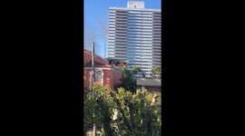 Fire Roaring Out of Los Angeles High Rise on Wilshire Blvd. Man Seen Climbing Out of Window.