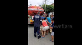 People in Colombia are aided with drinking water after a strong rainstorm