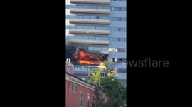 Desperate man climbs out window during building fire in Los Angeles