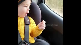 Toddler dancing in car seat