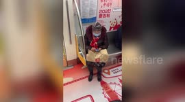 Chinese woman spotted covering head with plastic bottle on train during coronavirus outbreak