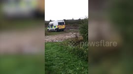 Motorist catches police mobile caught in mud