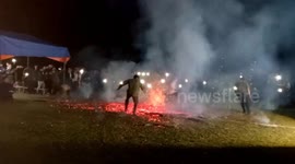 Men captured dancing on huge blaze during fire festival for Lunar New Year in Vietnam