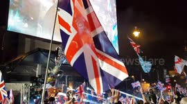 UK Brexit Day crowds with balloons and flags waving in Parliament Square London