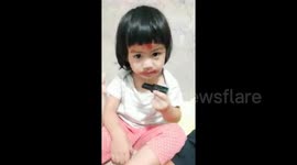 Adorable toddler accidentally puts lipstick on forehead