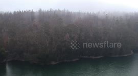 Flight over foggy reservoir
