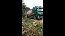 The driver drove the truck with dozens of wheels crossed the successful small road