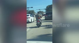 Parrot rides on the back of motorcycle with owner in Florida