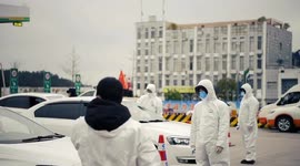 Workers in protective clothing check drivers’ temperatures on last day of Chinese New Year’s holidays