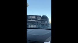 Shocking moment tractor-trailer blown over by high winds in California