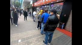 Hong Kong residents queue for protective masks as first death from coronavirus reported in the city