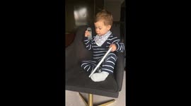 Baby pretending to work in the office on phone and computer