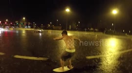 Man SURFS on flooded street in Italy
