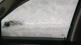 Motorist finds car covered in thick sheet of ice as snowstorm hits Canada