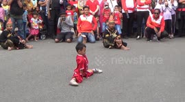 a 6-year-old child in Padang shows his skill at playing martial wusu