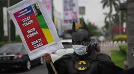 Indonesian man wears Batman costume to educate locals about coronavirus