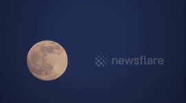 Full snow moon rises over the Derbyshire Dales in England