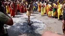 Bizarre and gruesome festival held in south India featuring flesh piercing and walking on hot coals