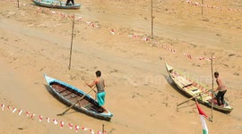 Farmers use sampan boats to cross mud-clogged riverbed in Indonesia