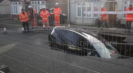 A motorist had a miracle escape after driving their car into a SINKHOLE - which opened on a suburban street