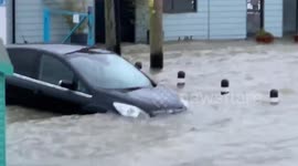 Cars float away during heavy flooding in Essex