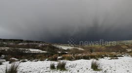 Snow squall edges towards filmer as storms batter UK