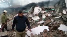 Burning building collapses and kills two firemen in north India
