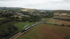 Drone footage of steam train travelling through the English countryside