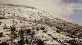 Drone Journey Along Snow-Covered Mountain