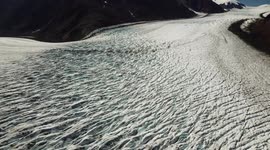 Watch this drone footage of a beautiful glacier curving its way through mountains on the US-Canada border