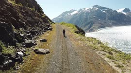 drone footage of amazing bike ride next to a glacier