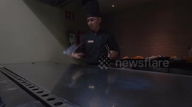 Hibachi chef in Mexico shows utensil flipping skills before cooking a meal
